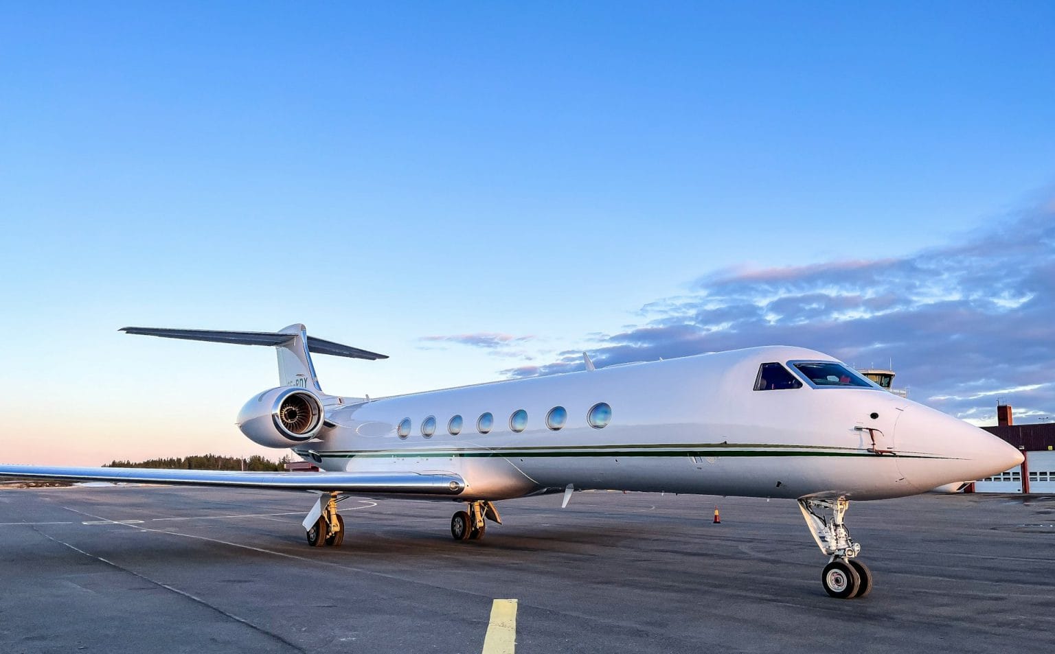 Private business jet parked on the apron at dusk