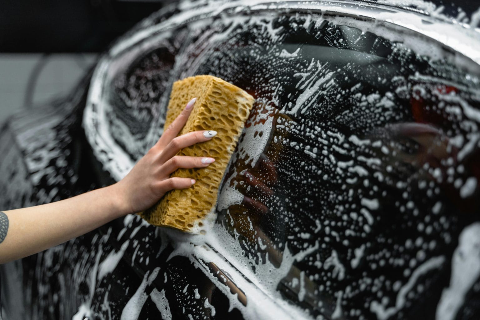 Car Detailing in Richmond Hill, GA: Mobile Detailing That Comes to You 1 Wash mitt lifting foam from a car body panel
