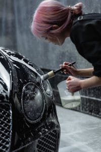 Mobile car detailing service washing vehicle at home in Bluffton SC - Lux Detailer mobile vs shop detailing comparison