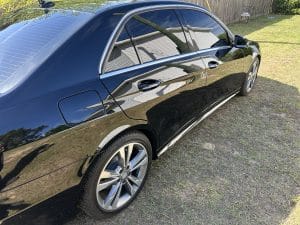Blog 6 Black Mercedes saloon with a mirror finish on grass
