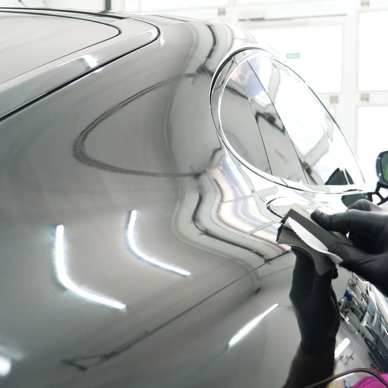 Wiping down a ceramic-coated panel during maintenance