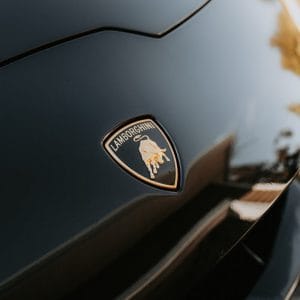 Close-up of deep gloss black bodywork reflecting light after an exterior detail