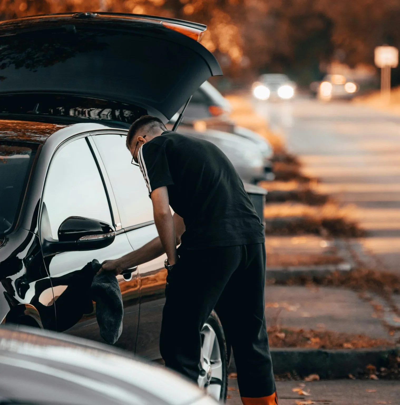 Mobile detailer hand drying a car